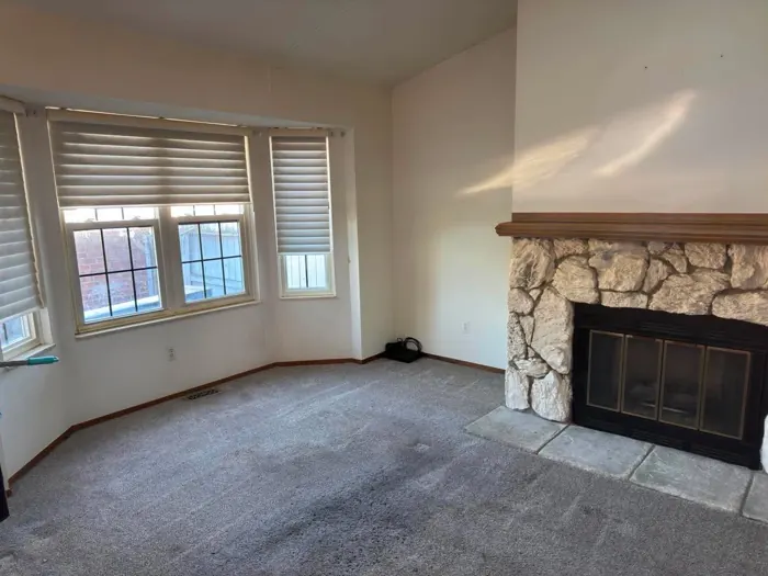 The same living room cleared, with the fireplace and floor visible